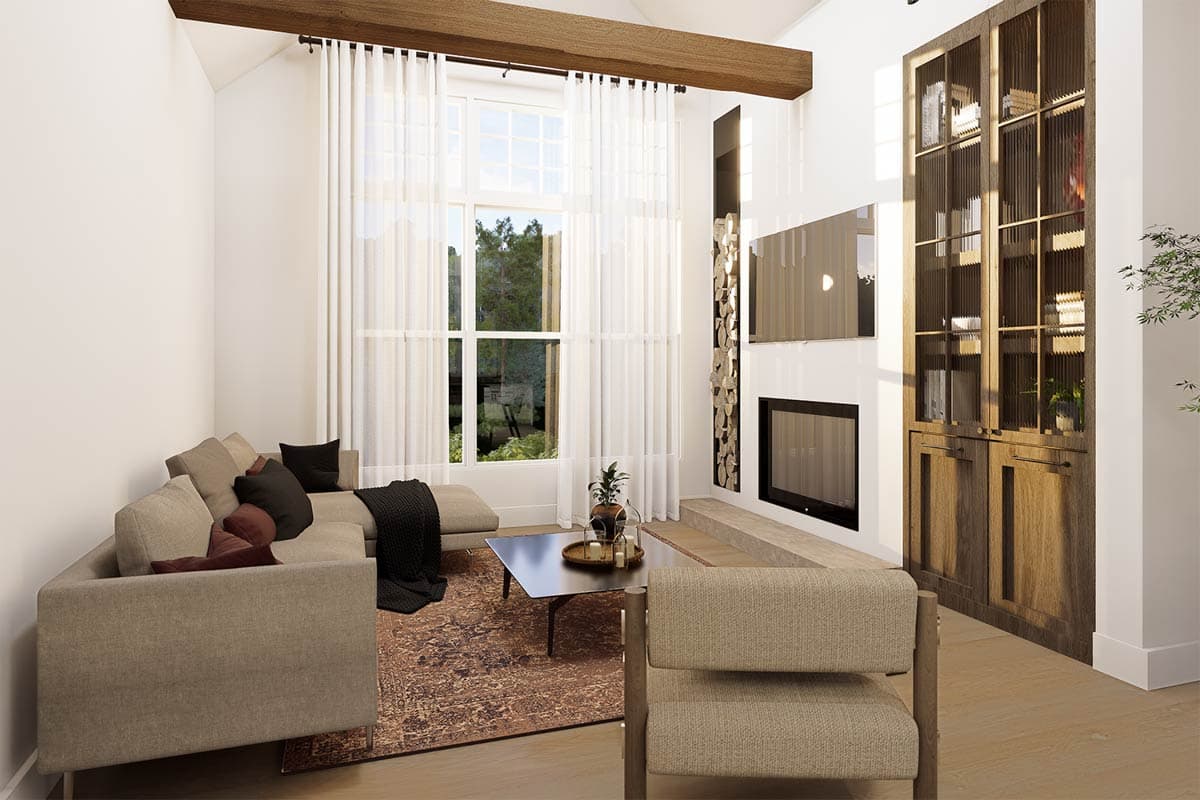 A modern living room featuring a sectional sofa, rug, fireplace, built-in shelving, and large window with sheer curtains, letting in light.