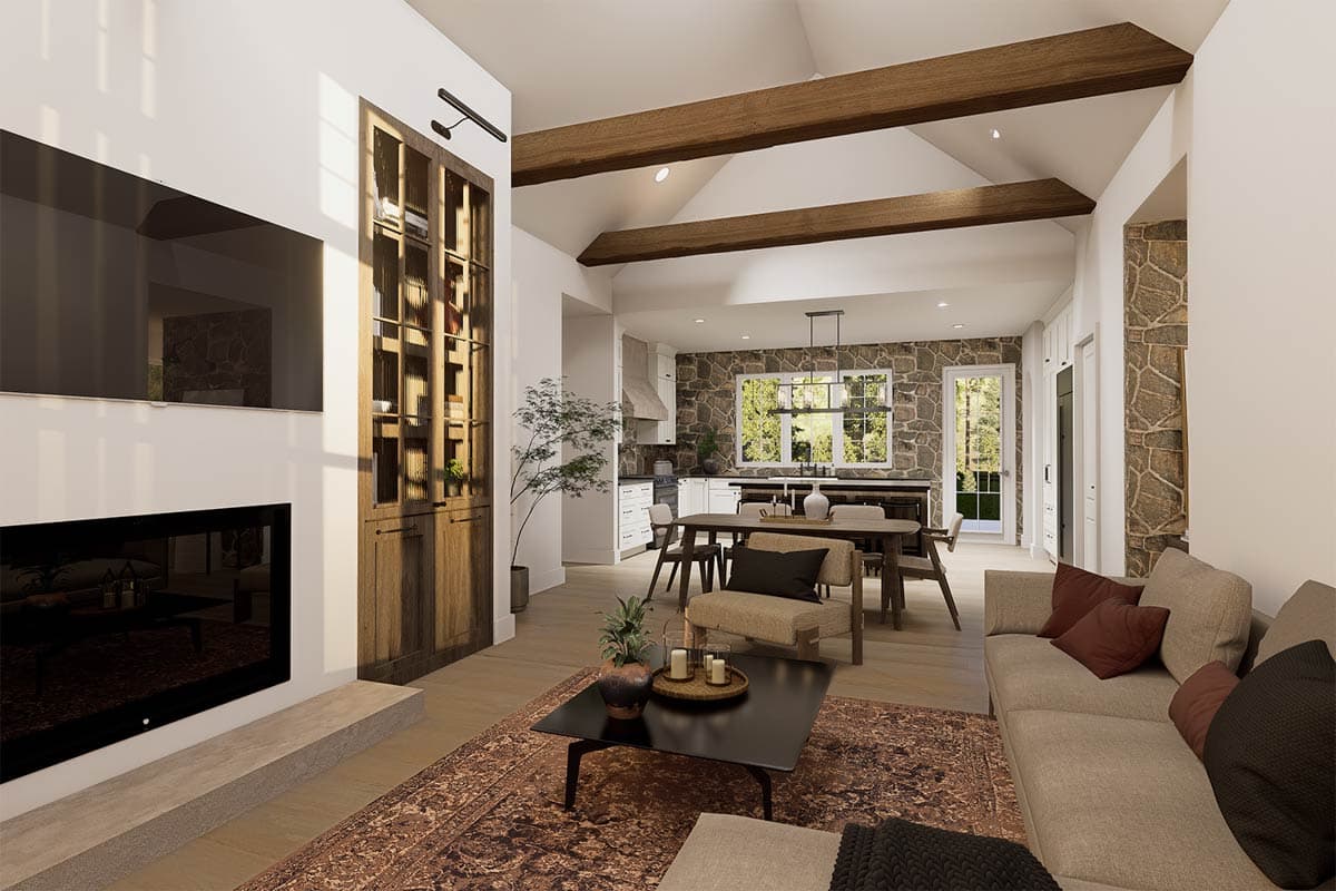 A modern, open-concept living space with a fireplace, built-in shelving, and a view into the kitchen and dining area.