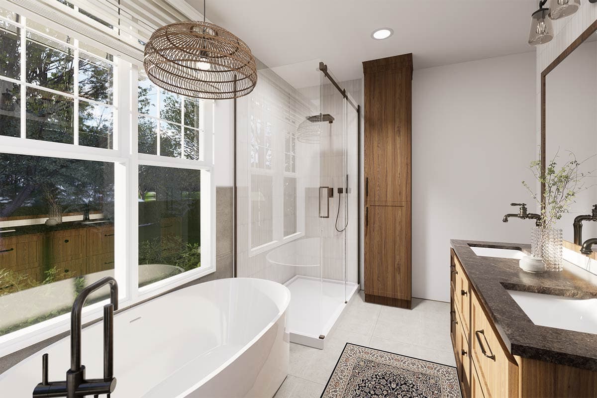 A modern bathroom features a freestanding tub near a large window, a glass shower, and a wooden vanity with double sinks. A woven light hangs above.