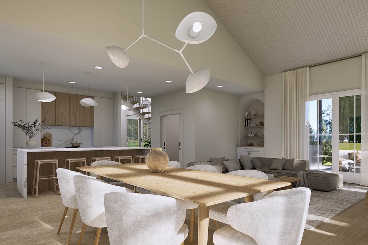 Spacious, modern dining room with a large wooden table and upholstered chairs. Kitchen in the background, a spiral staircase and contemporary lighting.
