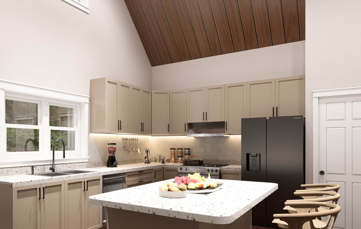 Kitchen with vaulted wood ceiling, light taupe cabinets, island, stainless steel appliances, and window.