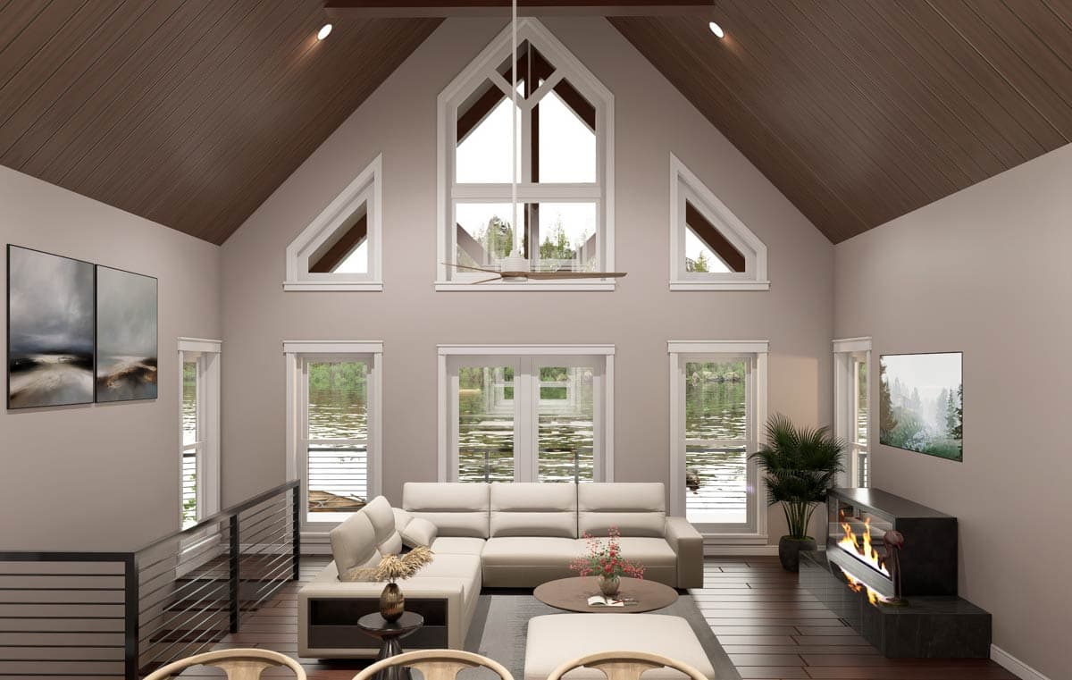 Great room with vaulted wood ceiling, fireplace, and wall of windows overlooking water.