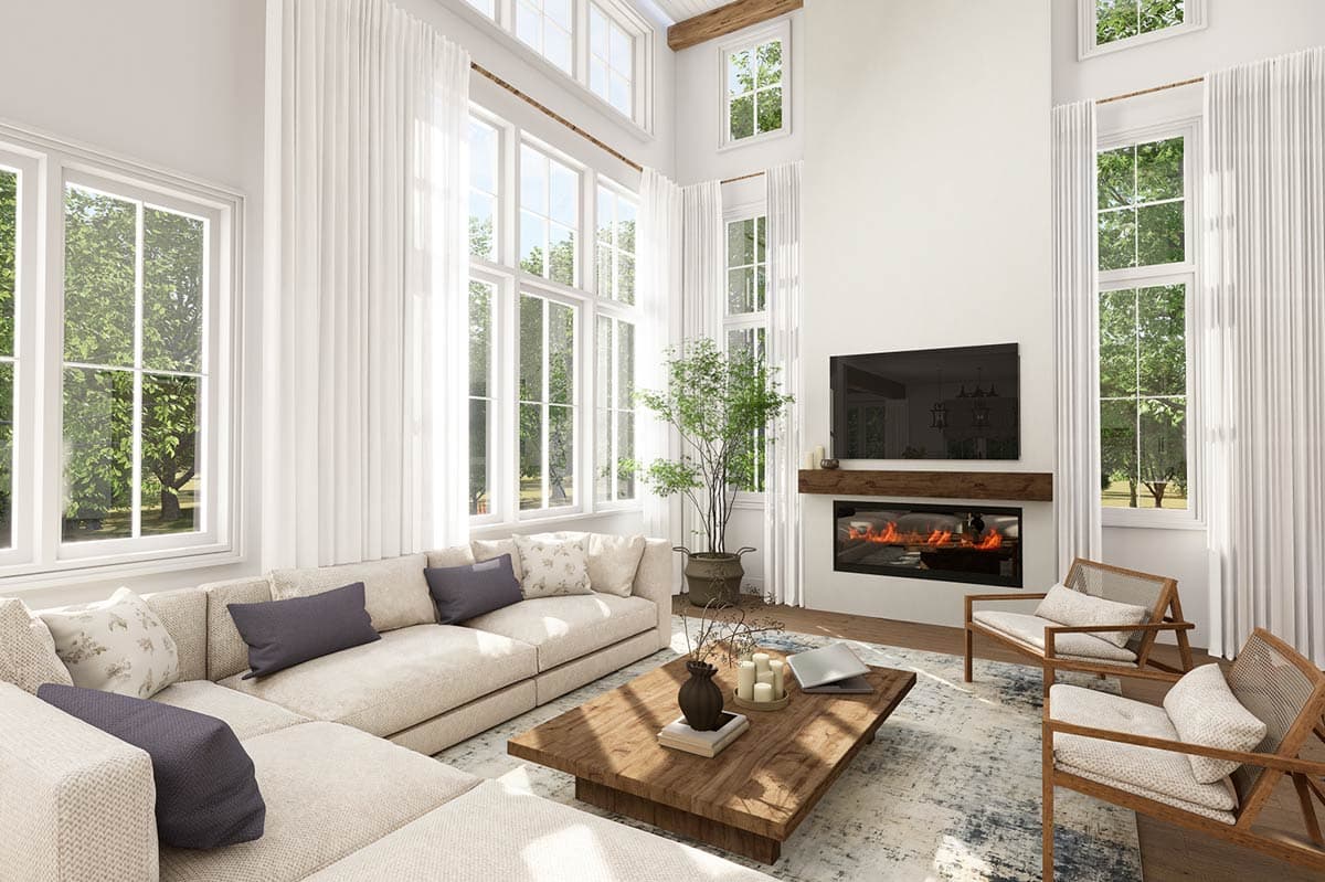 Great room with vaulted ceiling, large windows, fireplace, and sectional sofa.