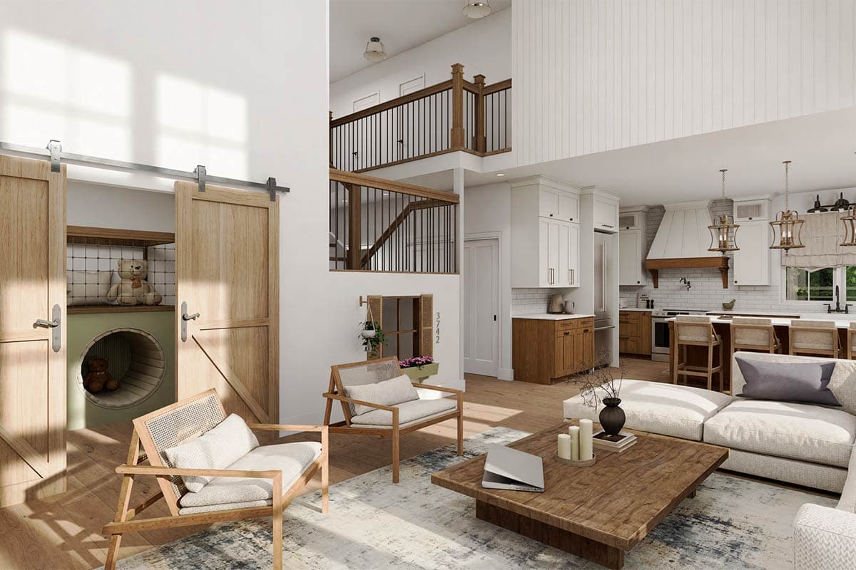 Open concept living area with kitchen, dining, and living spaces, featuring barn doors and a second-story balcony.