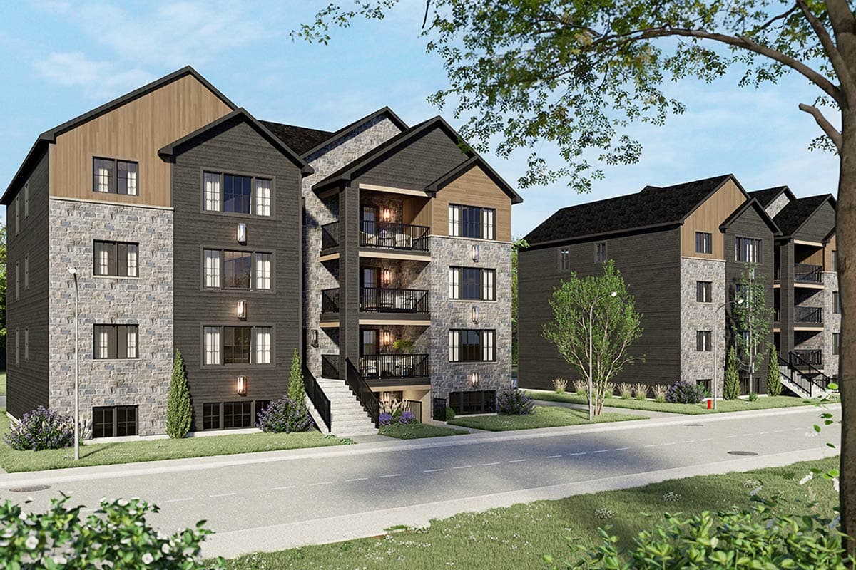 Modern multi-story apartment building exterior with stone and wood siding, balconies, and gabled rooflines.