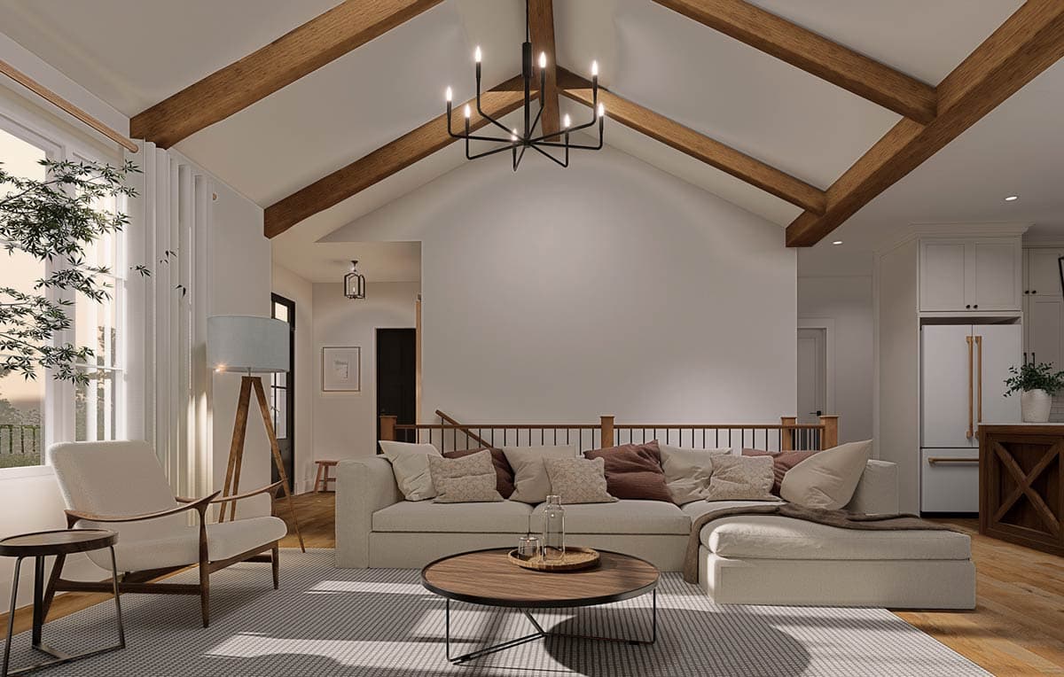 Interior rendering of a great room with vaulted ceilings, exposed wood beams, large windows, and a sectional sofa.