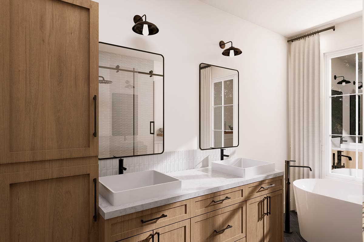 Bathroom vanity with two vessel sinks, wood cabinetry, glass-enclosed shower, and freestanding tub.