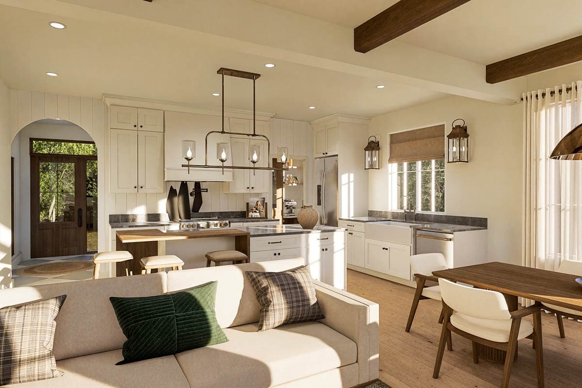 Open-concept living area with kitchen, dining, and seating zones. Features include wood beams, island, and farmhouse sink.
