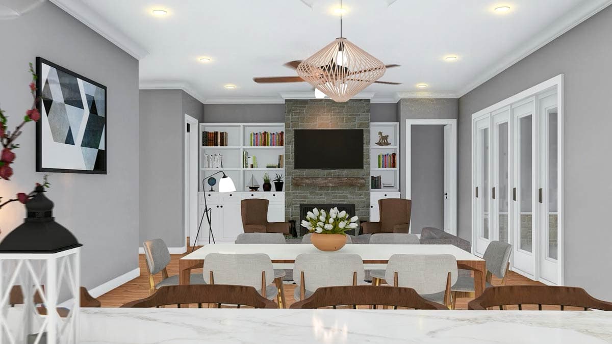 Open concept dining and living area with stone fireplace, built-in bookshelves, and glass-paneled doors.