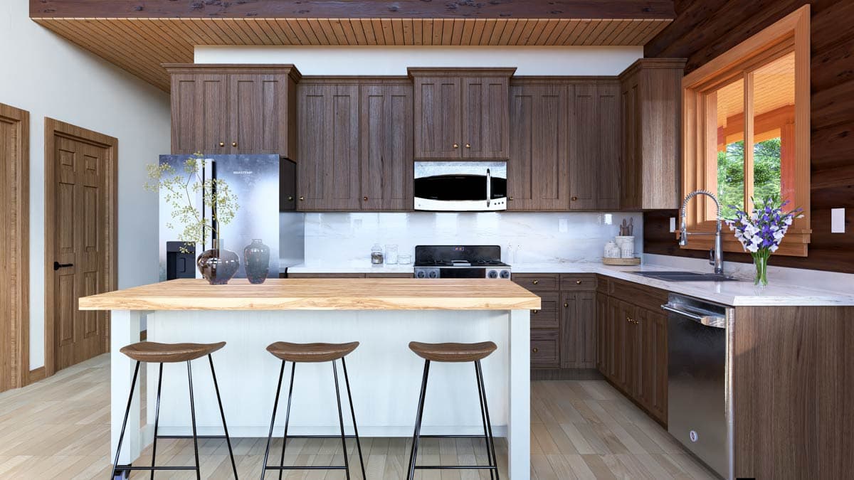 Kitchen with wood cabinets, island with bar stools, stainless steel appliances, and wood beams on the ceiling.