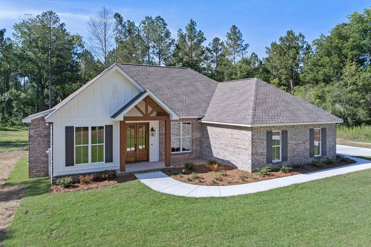 Modern Farmhouse exterior, one story, brick and board-and-batten siding, wood-supported gable entry porch, dark shutters.