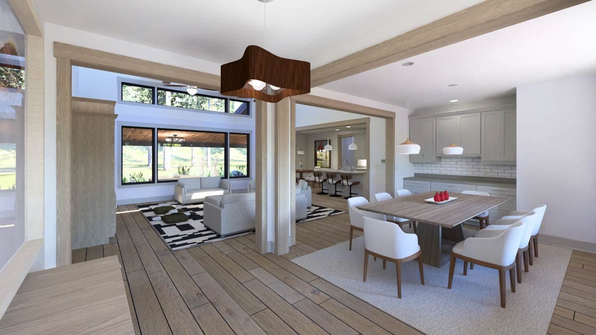 Open-concept living area with dining room, kitchen island, and great room featuring large windows and wood beams.