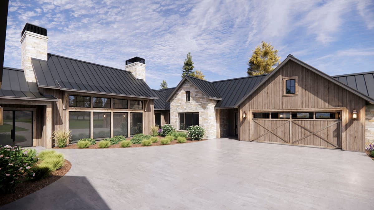 Modern farmhouse with a dark roof and stone and wood siding. A curved driveway leads to the garage and front entrance, with manicured landscaping.