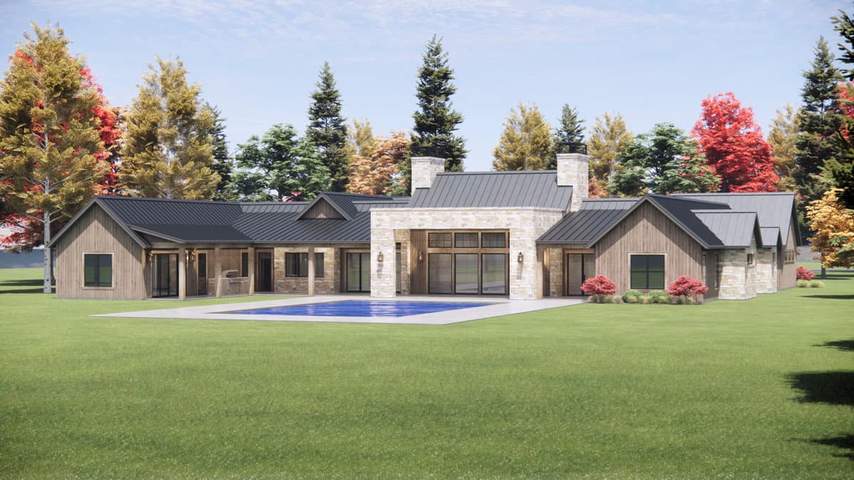 A modern, single-story house with a pool, stone facade, and dark roof. Trees with autumn foliage frame the exterior, sitting on a grassy lawn.