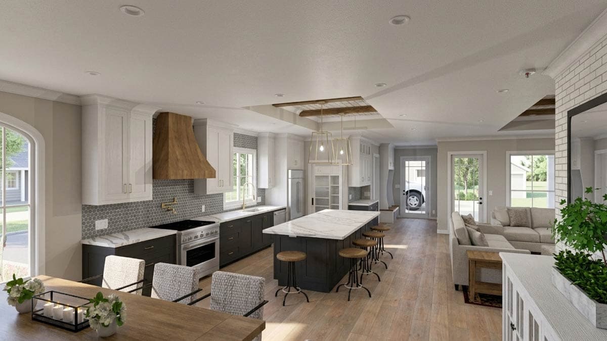 Open concept kitchen and great room with large island, range hood, and sectional sofa.