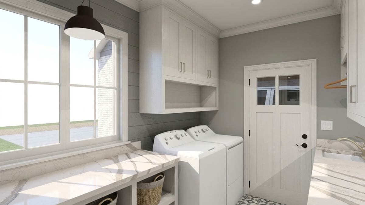 Laundry room with white washer and dryer, overhead cabinets, marble countertop, and a glass-paneled door.