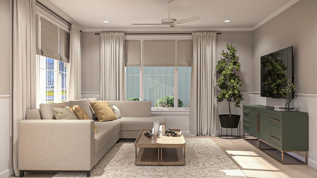 Living room with sectional sofa, coffee table, and media console with mounted TV. Features large windows, ceiling fan.