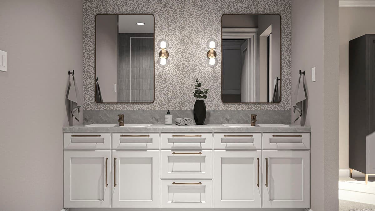 Bathroom with double vanity, two mirrors with gold sconces, and patterned wallpaper.