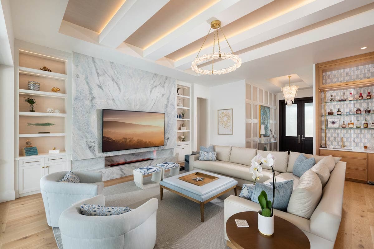 Living room with sectional sofa, fireplace, built-in shelving, and bar.