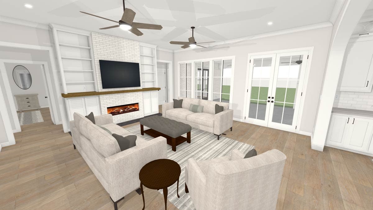 Living room with sofas, fireplace, and built-in shelves.  French doors open to a backyard. The room has neutral tones and elegant design.
