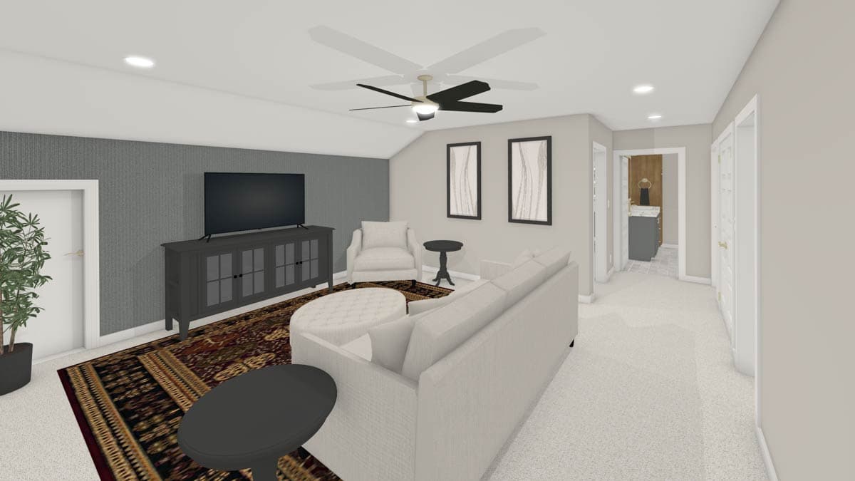 A modern living room with a large TV, neutral-colored furniture, an ornate rug, and a ceiling fan. A hallway leads to a bathroom.