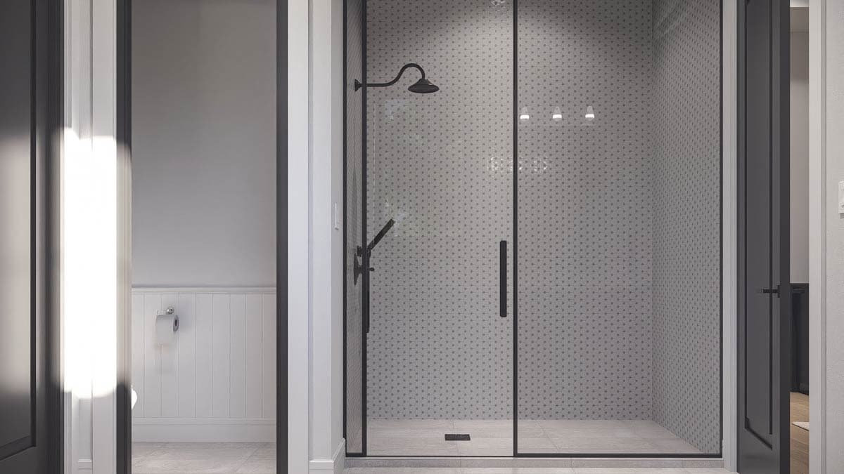 Modern bathroom with glass-enclosed shower featuring black fixtures and patterned tile. Toilet visible in adjacent room.