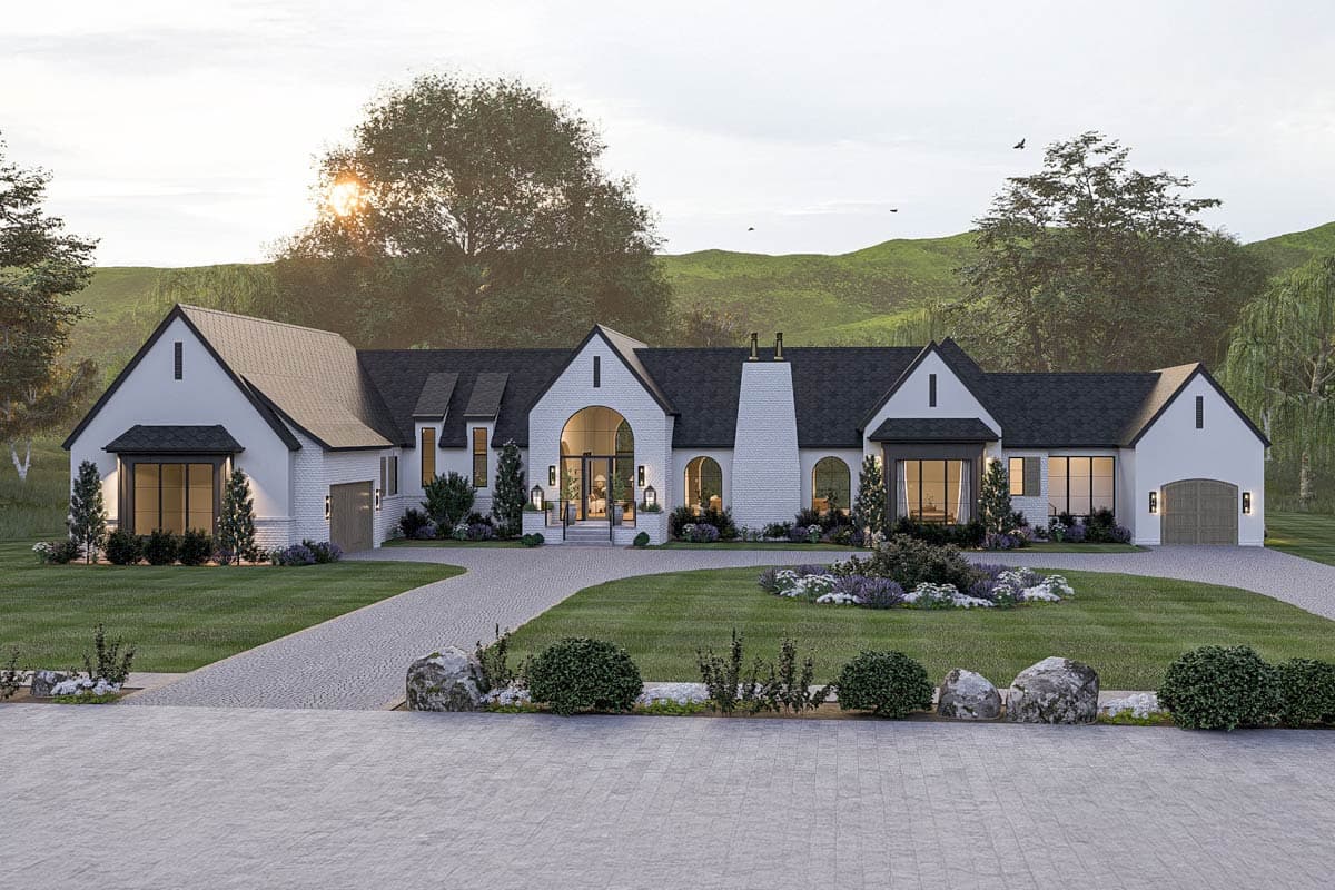 House plan exterior featuring a two-story design with a gabled roof, arched entry, and attached garage. Includes a long driveway.