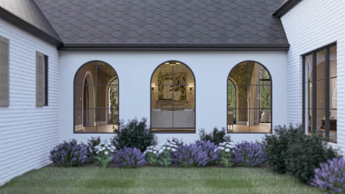 House plan exterior with white brick, arched windows, dark metal window frames, and a dark shingled roof.