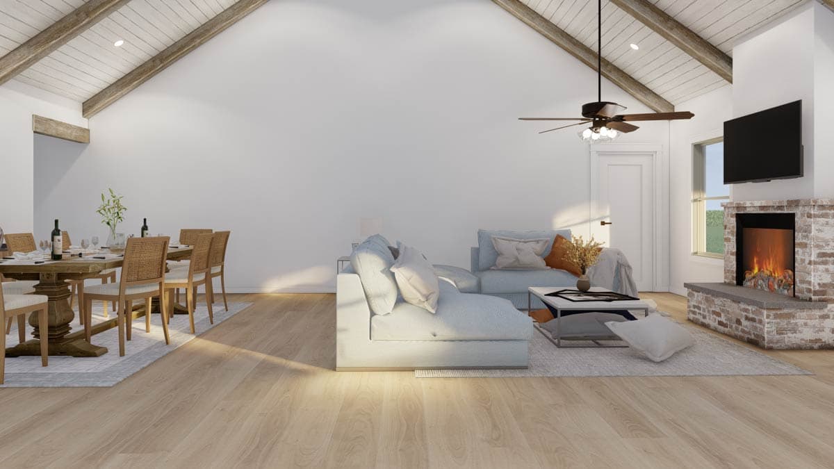 Open-plan living and dining area with vaulted beam ceiling, fireplace, and TV.