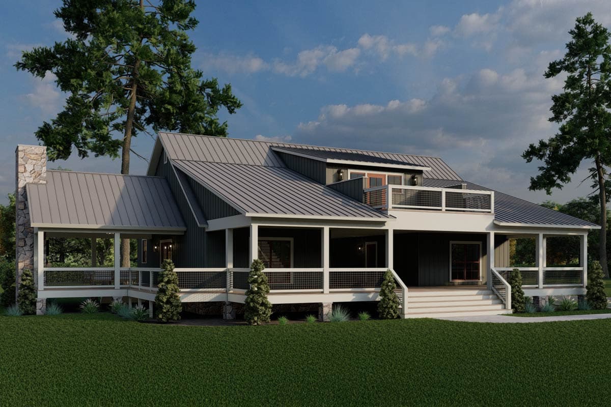 Modern Farmhouse house plan exterior with a metal roof, stone chimney, wraparound porch, and upper balcony.