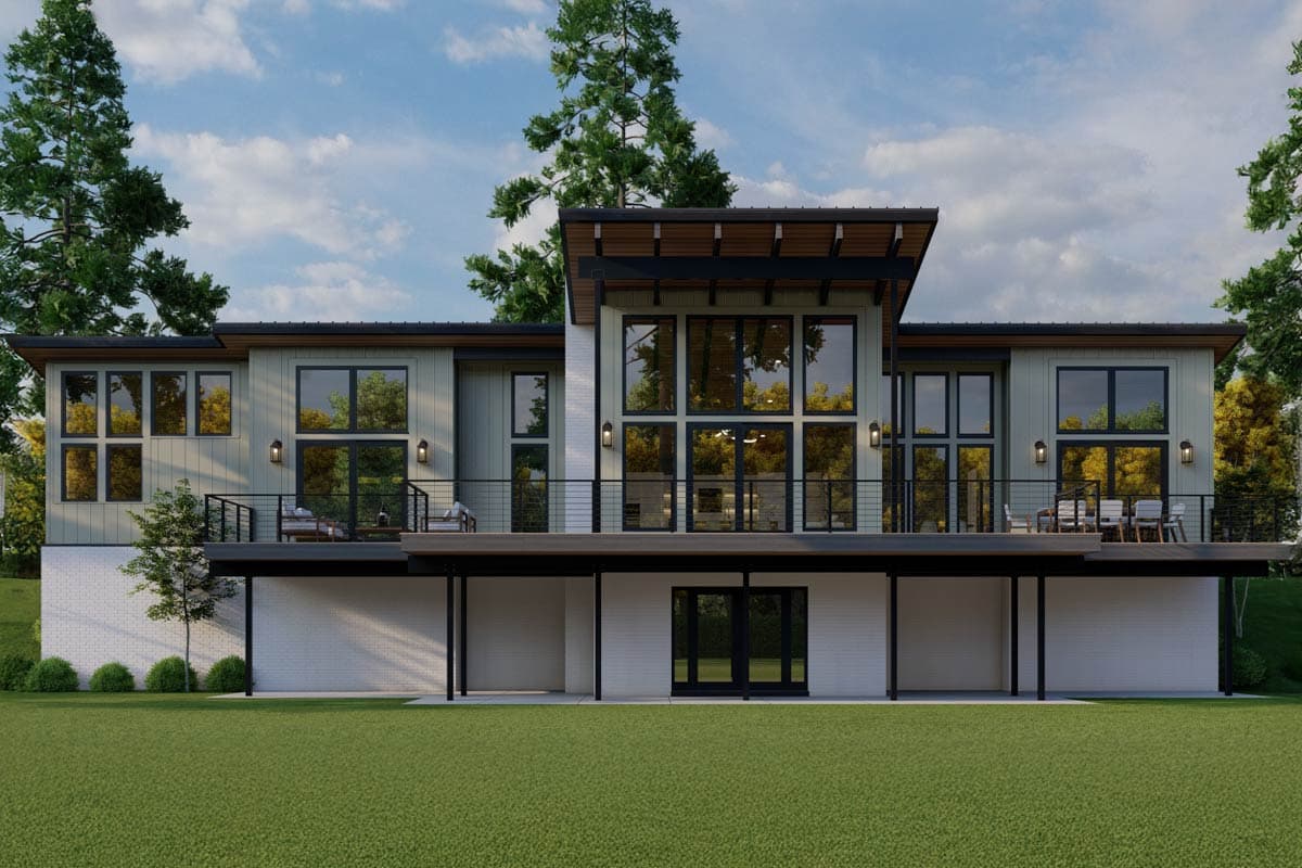 Modern house plan exterior featuring a two-story design with a cantilevered deck, extensive glazing, and a mixed-material facade.