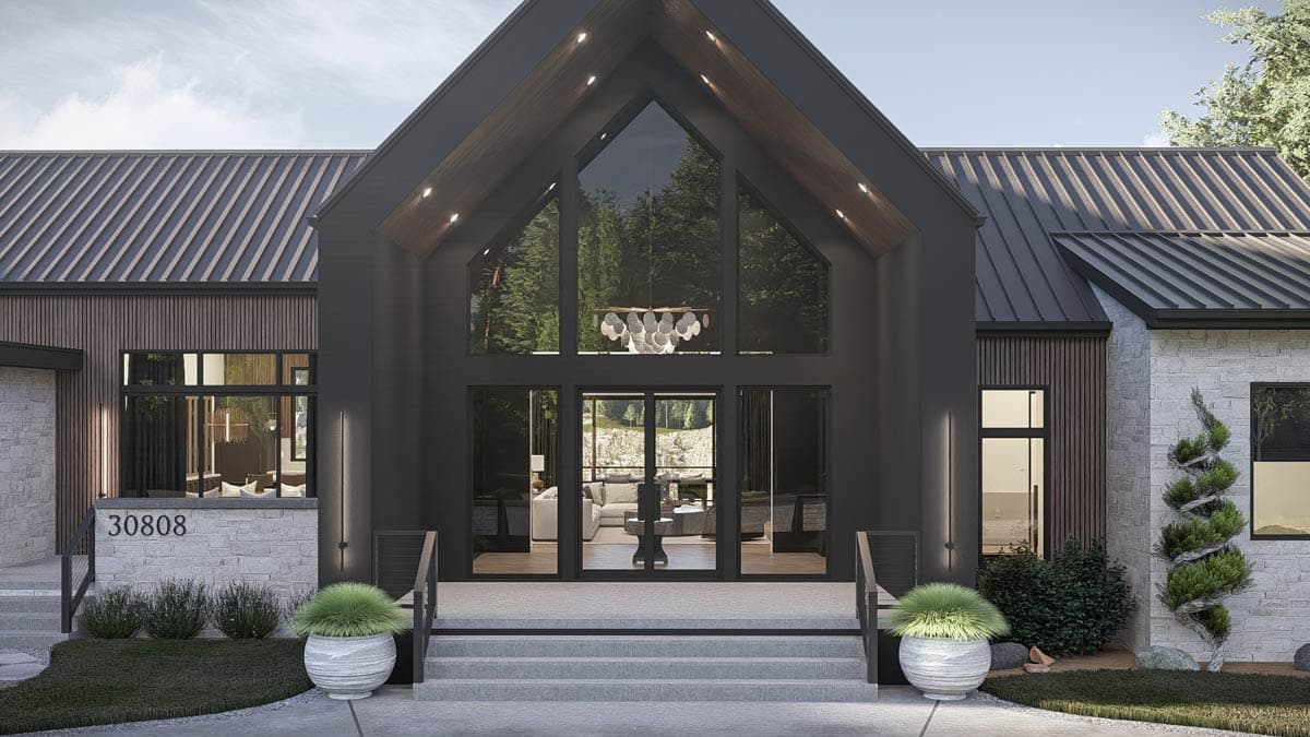 Modern house plan exterior with a tall gable, dark metal roof, stone and wood siding, and a grand glass entrance.