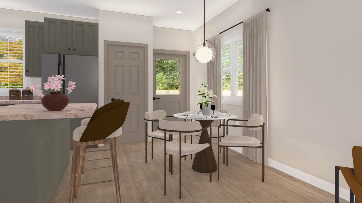 Dining area with round table and chairs adjacent to kitchen with island, stainless steel refrigerator, and gray cabinets.