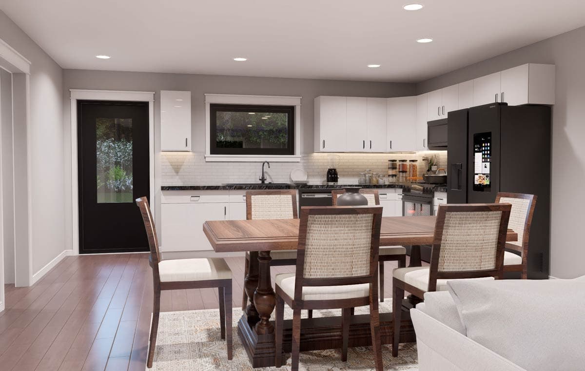Modern kitchen and dining area with white cabinets, dark countertops, wooden dining set, and a glass-paneled door.