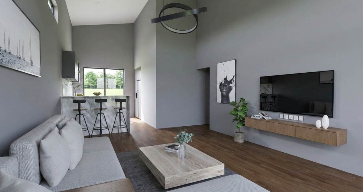 Open-concept living and kitchen area with vaulted ceilings, a sofa, breakfast bar with stools, and a wall-mounted TV.