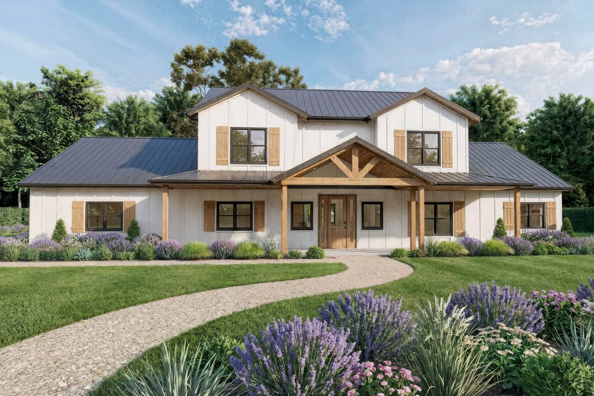 A white farmhouse with a dark gray roof and a wooden porch. A stone path leads to the front door, lined with flowers and lush green grass.