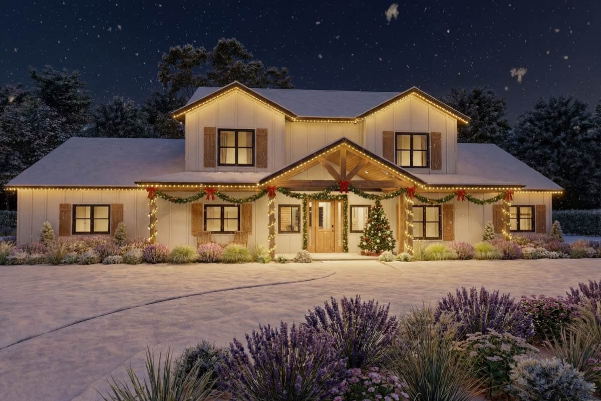 A snow-covered house at night, decorated with Christmas lights and garlands. A decorated Christmas tree sits by the front door, with falling snow in the sky.