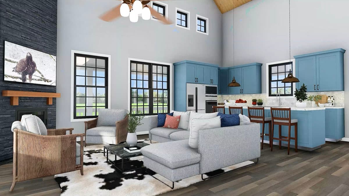 Great room and kitchen with vaulted ceiling, stone fireplace, blue cabinetry, and island seating.