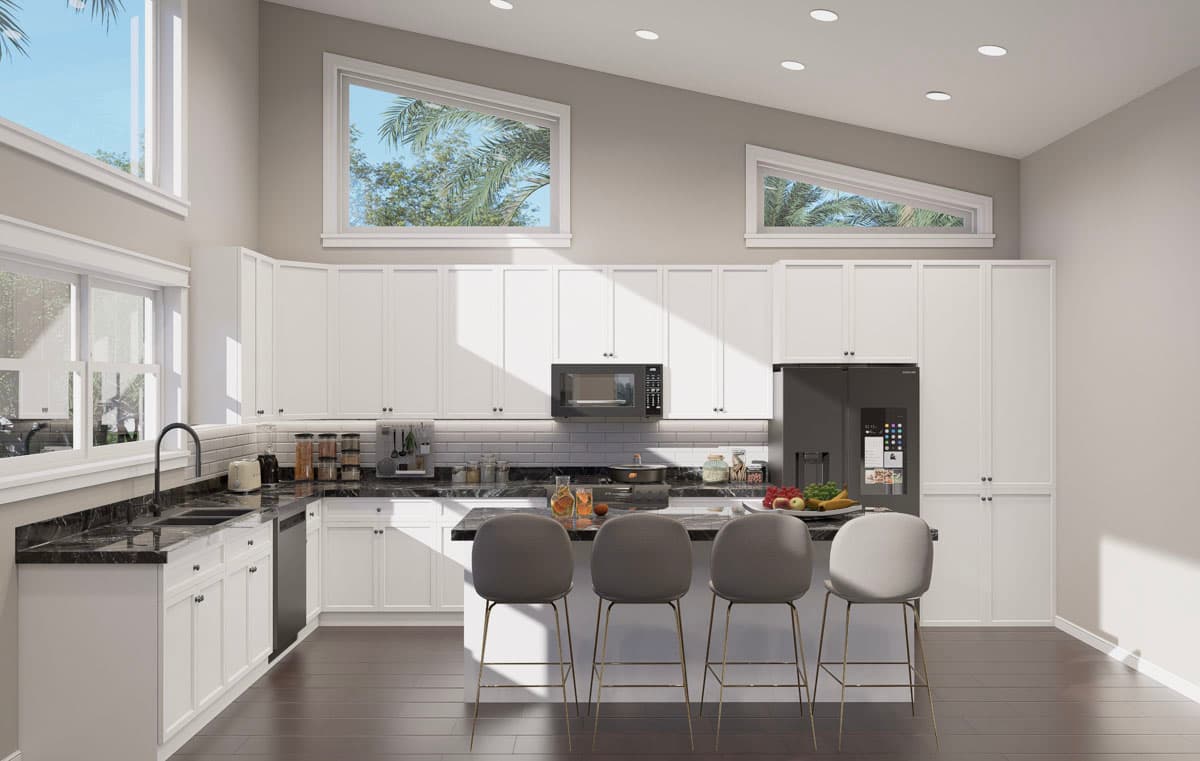 Interior view of a modern kitchen with white cabinets, vaulted ceiling, large windows, and a central island with bar stools.