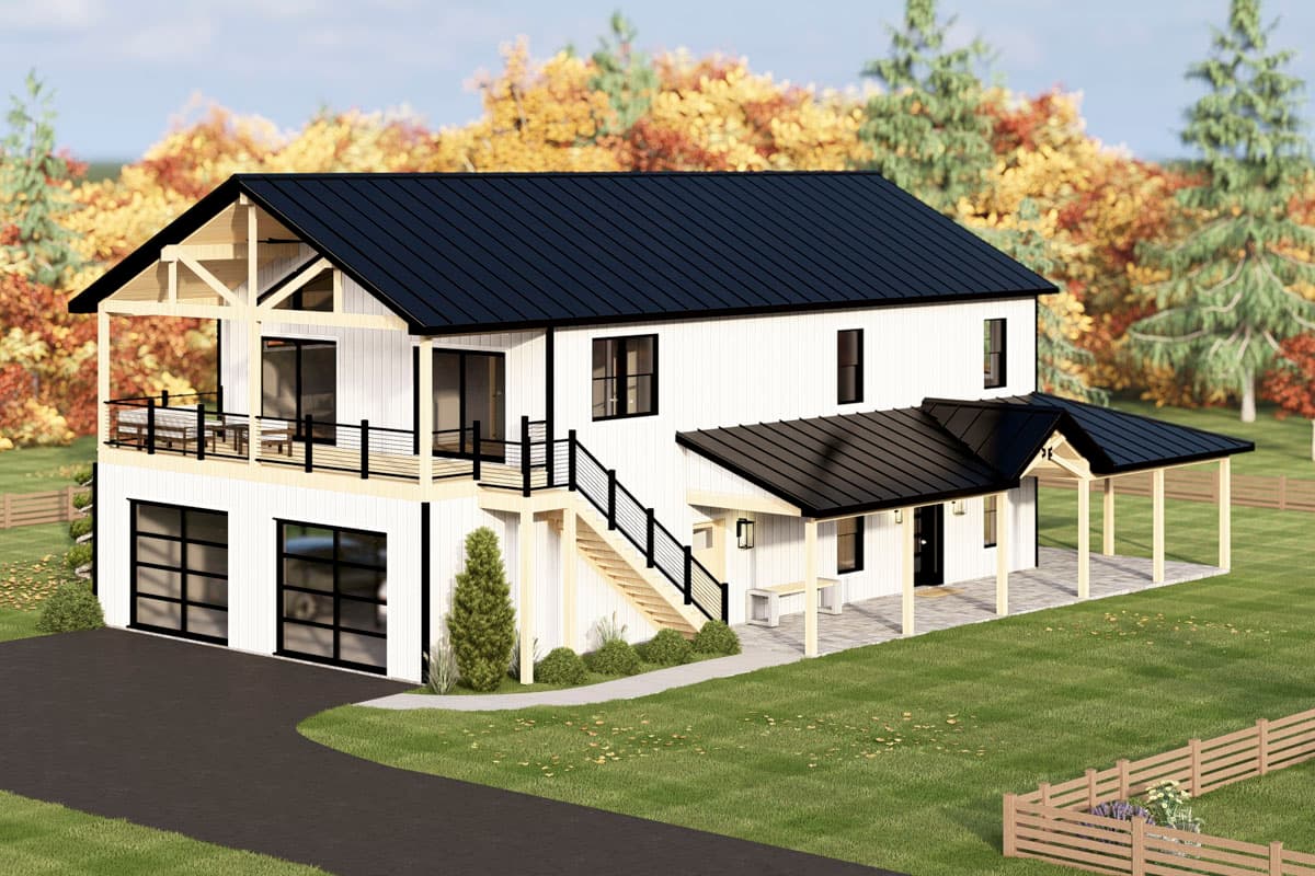 A modern, two-story house with a black roof and white siding is surrounded by green grass and autumn-colored trees.