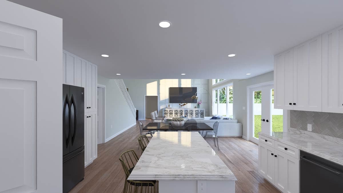 Open-concept interior: kitchen with island, dining area, and great room with fireplace and large windows.