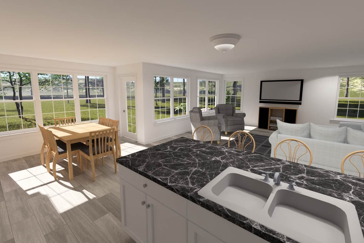 Open concept living area with dining nook, kitchen island with sink, and living room with sofa and chairs.