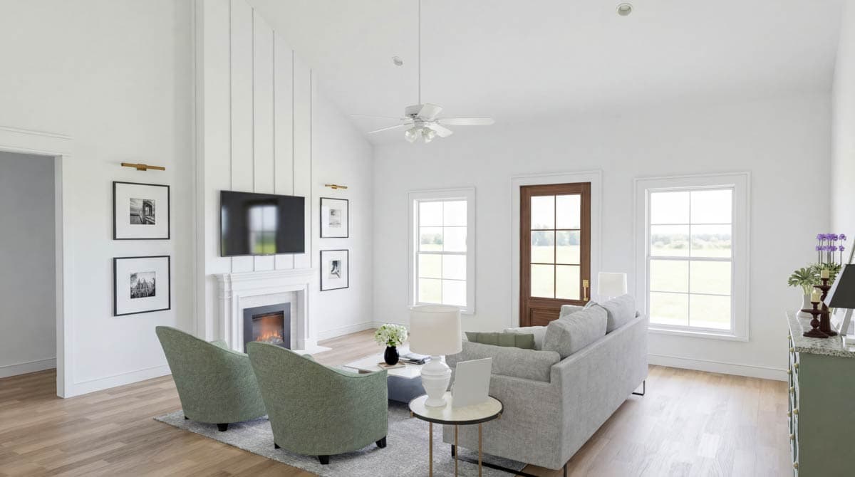 Living room with vaulted ceiling, fireplace, TV, and two green accent chairs. Features shiplap wall, wood-paneled door, and large windows.