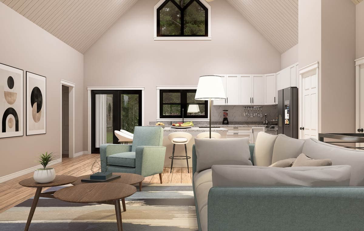 Open concept living area and kitchen with vaulted ceiling, island, and modern furnishings.