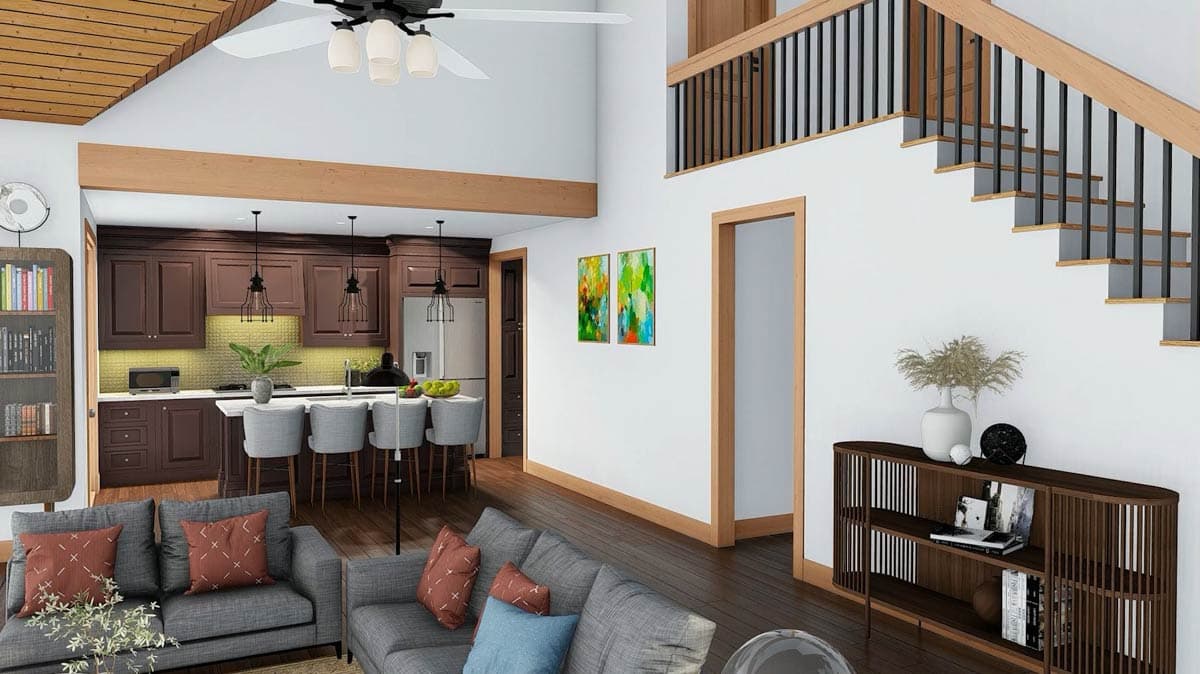Open concept living area with vaulted wood-paneled ceiling, kitchen island, dark wood cabinets, and open staircase with black railings.