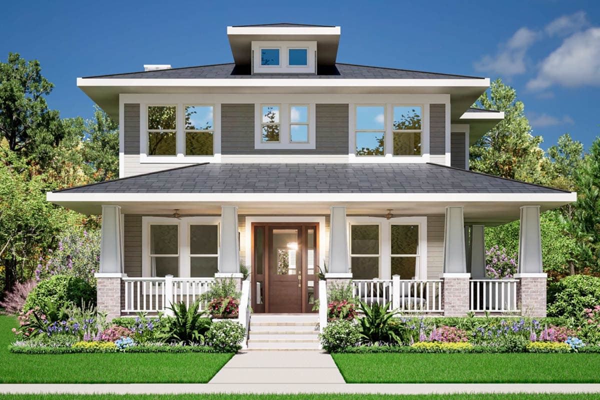 A two-story house with a welcoming porch and a dark roof. Lush landscaping frames the front entrance and a well-manicured lawn.