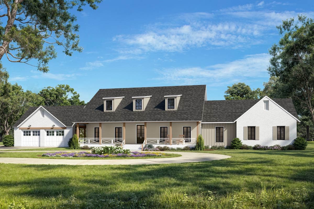 A large, farmhouse style home with three dormers above a wrap-around porch and a circular driveway on a well-manicured lawn under a bright blue sky.