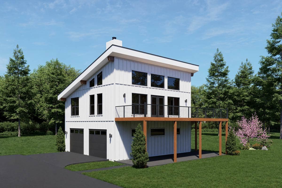 Modern two-story house with white siding, black-framed windows, and a black roof. It features a deck, garage, and is surrounded by trees.