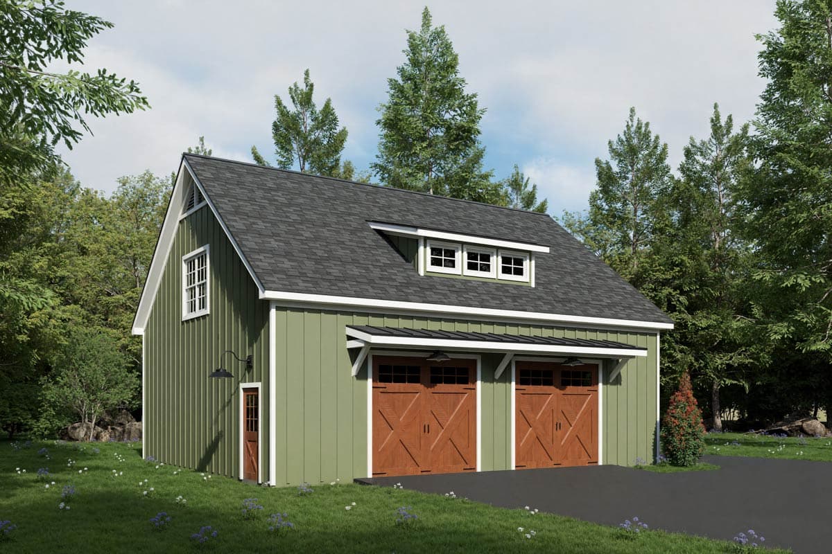 A two-car garage with green siding and brown garage doors. The building has a dark gray roof, small windows, and is set against a backdrop of trees.