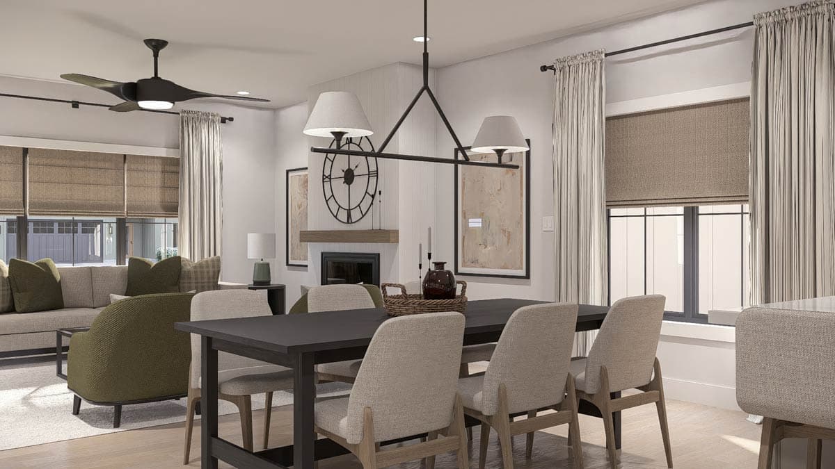 Dining area with dark wood table and upholstered chairs, adjacent to living area with sofa and fireplace.